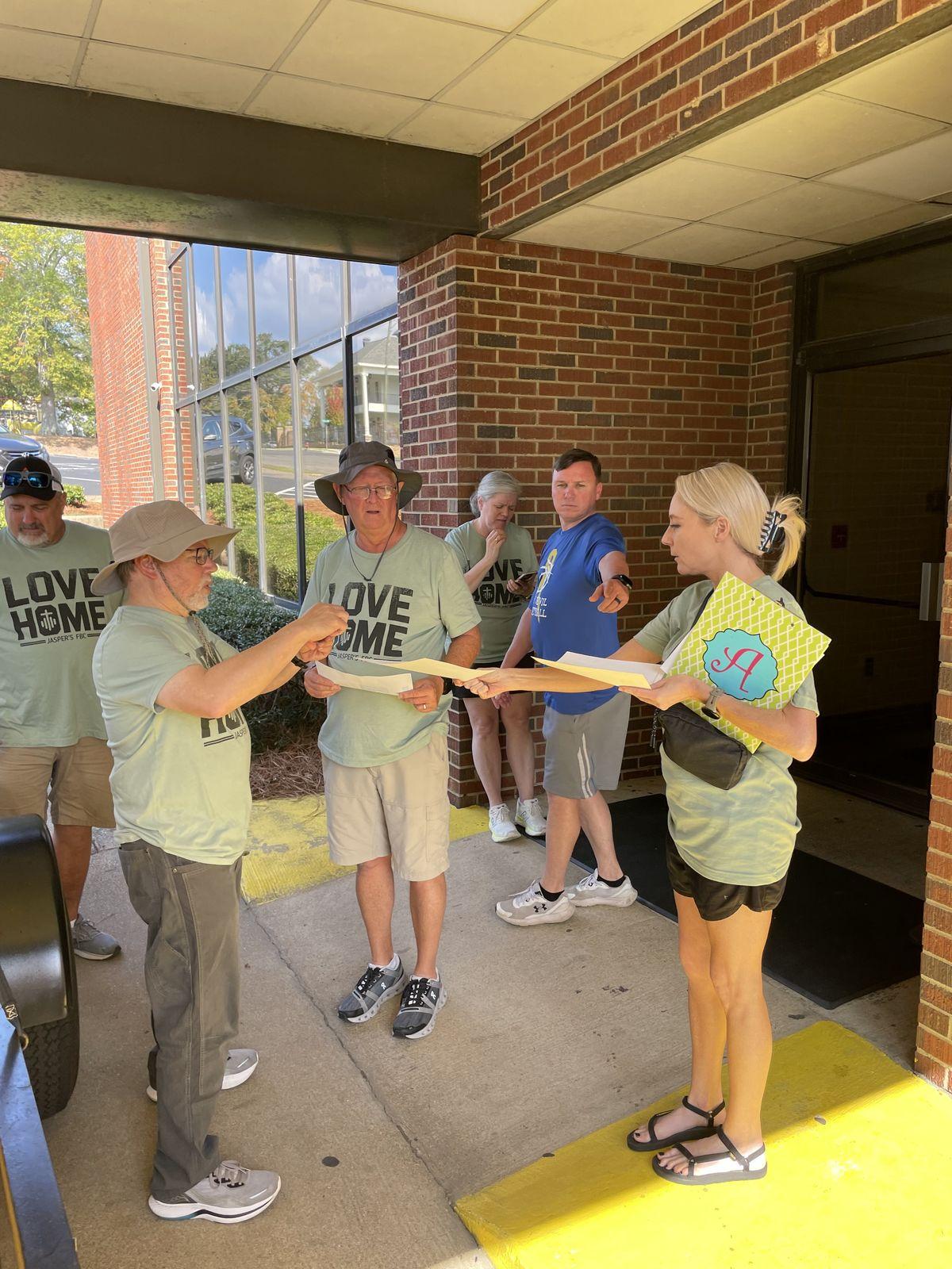 Volunteers planning in Love Home shirts