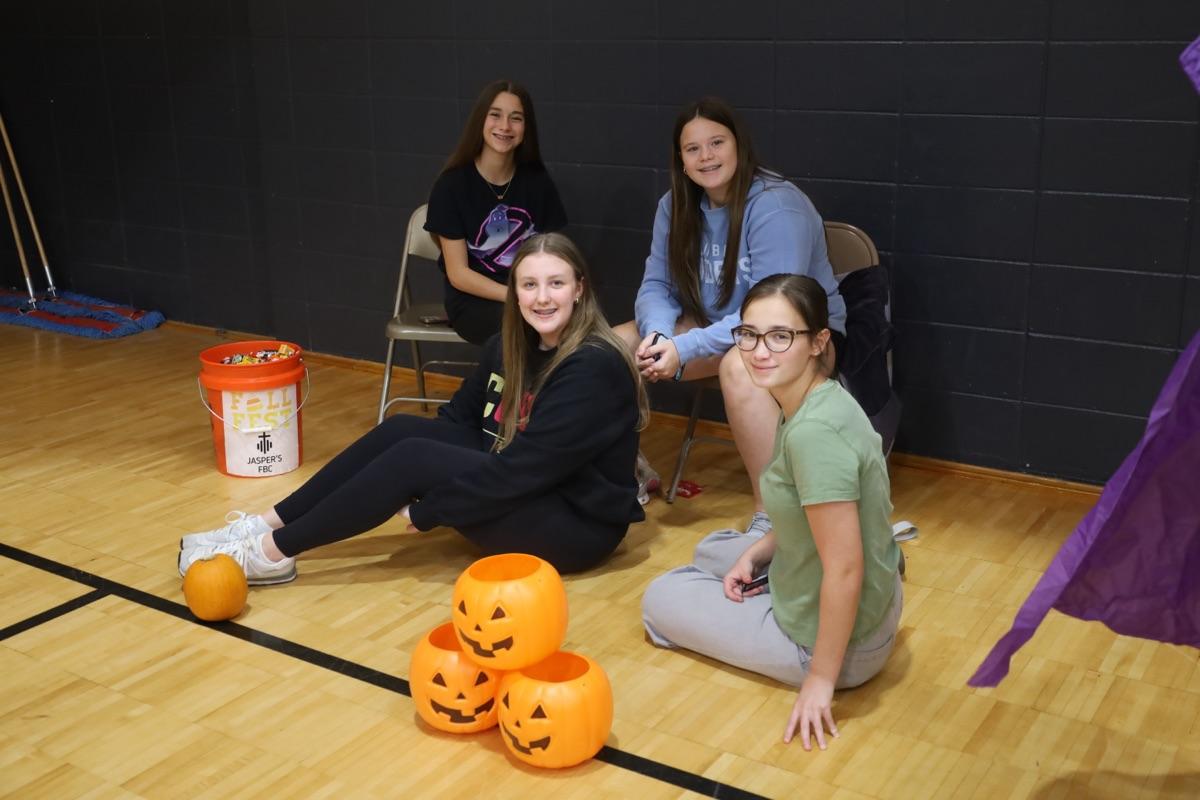 Volunteers at pumpkin bucket toss station
